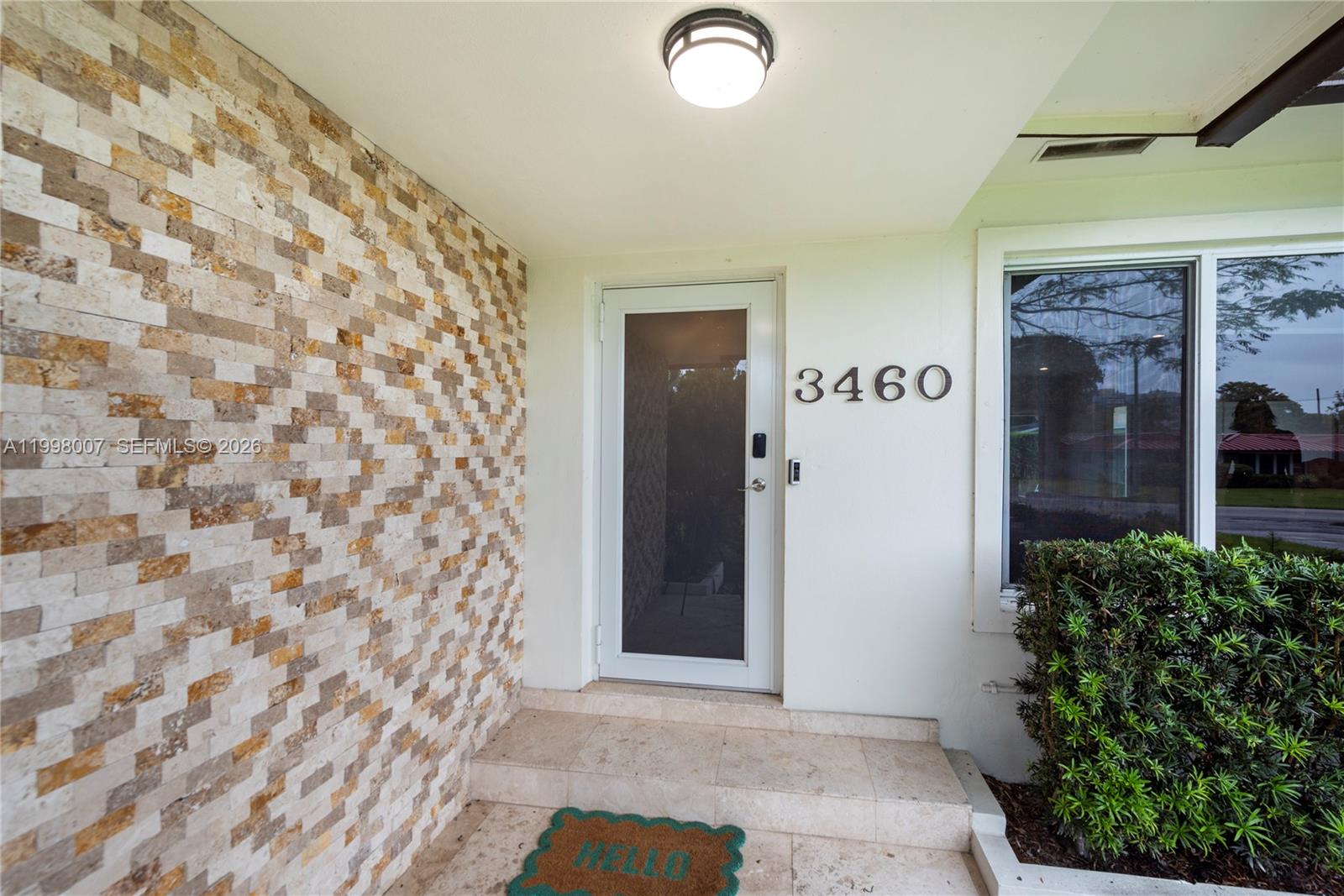 A front entryway features a stone-tiled accent wall, a glass door, and house number 3460 — 3460 Buchanan St, Hollywood FL 33021, HOLLYWOOD, FL
