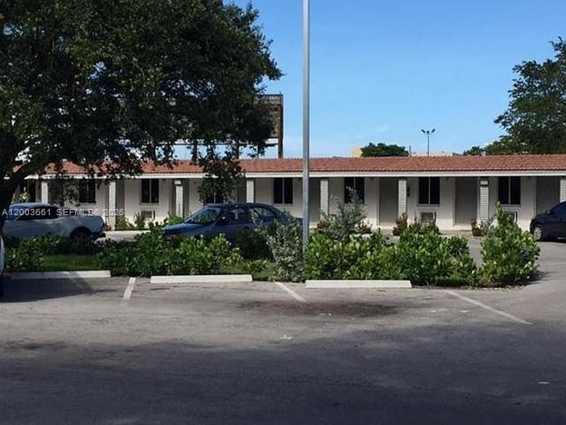 A single-story motel building with a parking lot in the foreground — 371 NE 80th Ter # 12, Miami FL 33138, MIAMI, FL