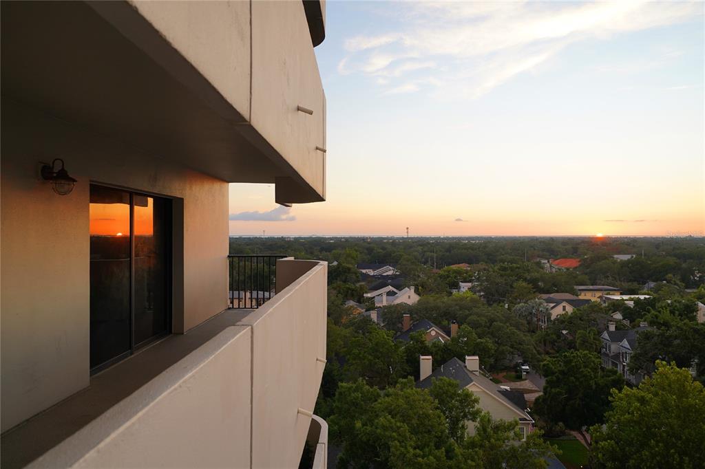 A high-rise balcony overlooks a suburban neighborhood during a sunset — 4141 BAYSHORE BOULEVARD UNIT 1106, TAMPA, FL