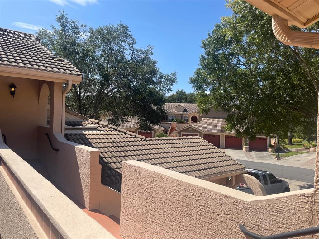 An elevated view of a residential complex with tiled roofs and stucco walls — 7786 SUGAR BEND DRIVE UNIT 7786, ORLANDO, FL
