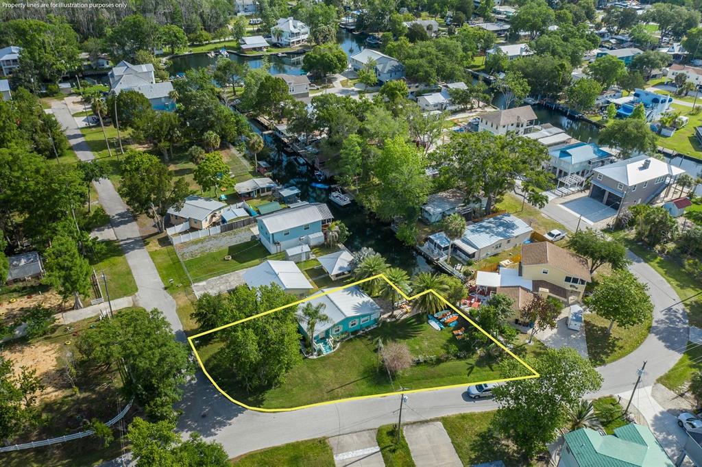 An aerial view shows a single-story house with a large yard outlined in yellow — 5473 DARLENE STREET, WEEKI WACHEE, FL