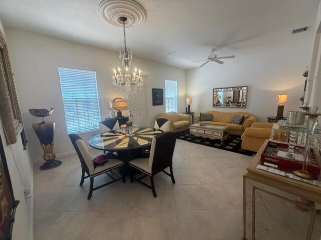 A dining and living area features tile floors, a crystal chandelier, and yellow upholstered furniture — 8288 NW 9th Avenue, Boca Raton FL 33487, BOCA RATON, FL