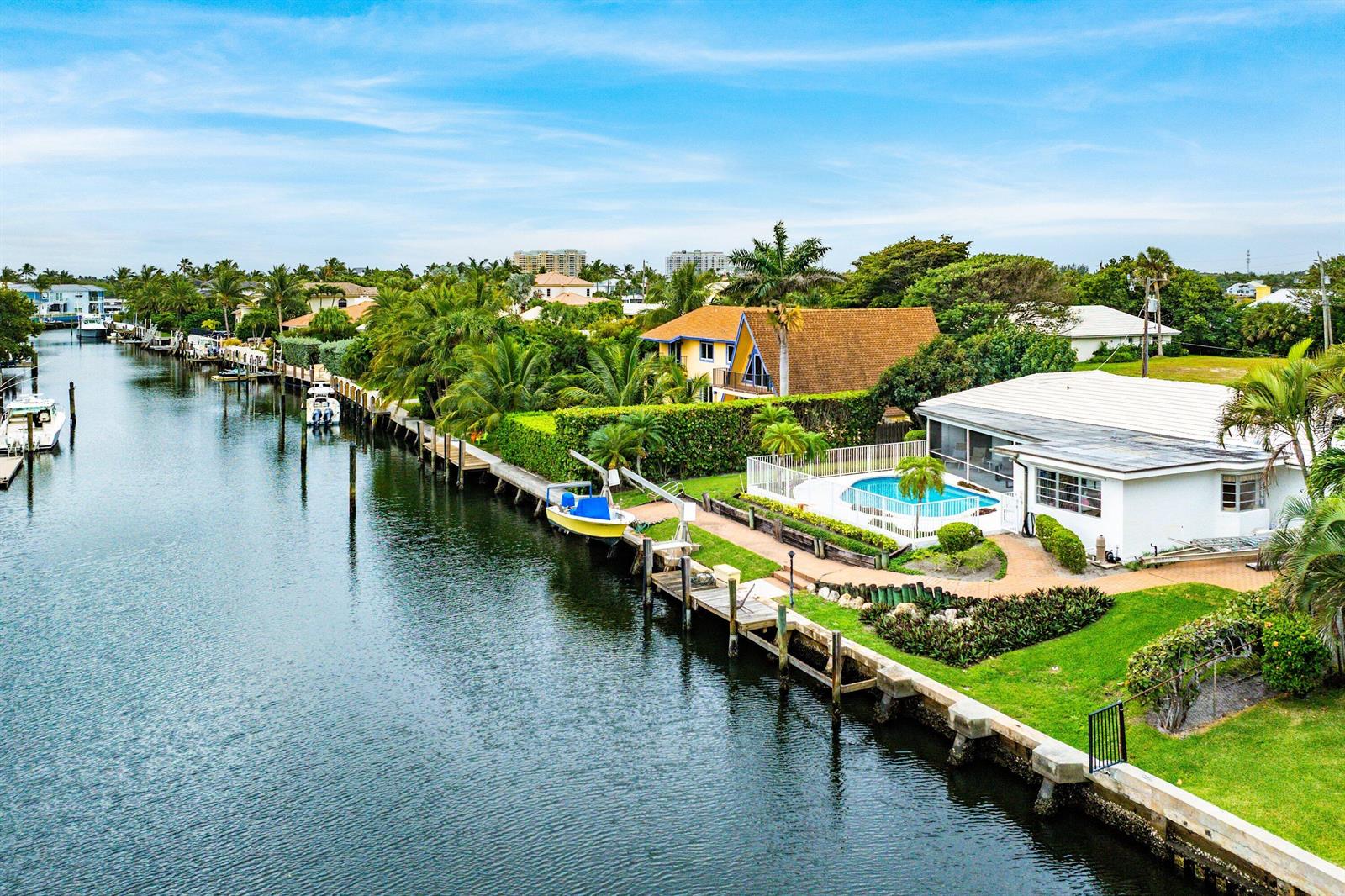 An aerial view of a waterfront house with a pool, dock, and boat lift — 23 Sabal Island Drive, Ocean Ridge FL 33435, OCEAN RIDGE, FL