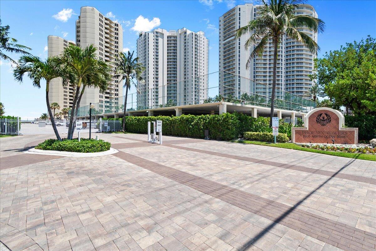 An exterior view of a paved driveway leading to a residential high-rise complex — 2800 N Ocean Drive # 18c, Riviera Beach FL 33404, RIVIERA BEACH, FL