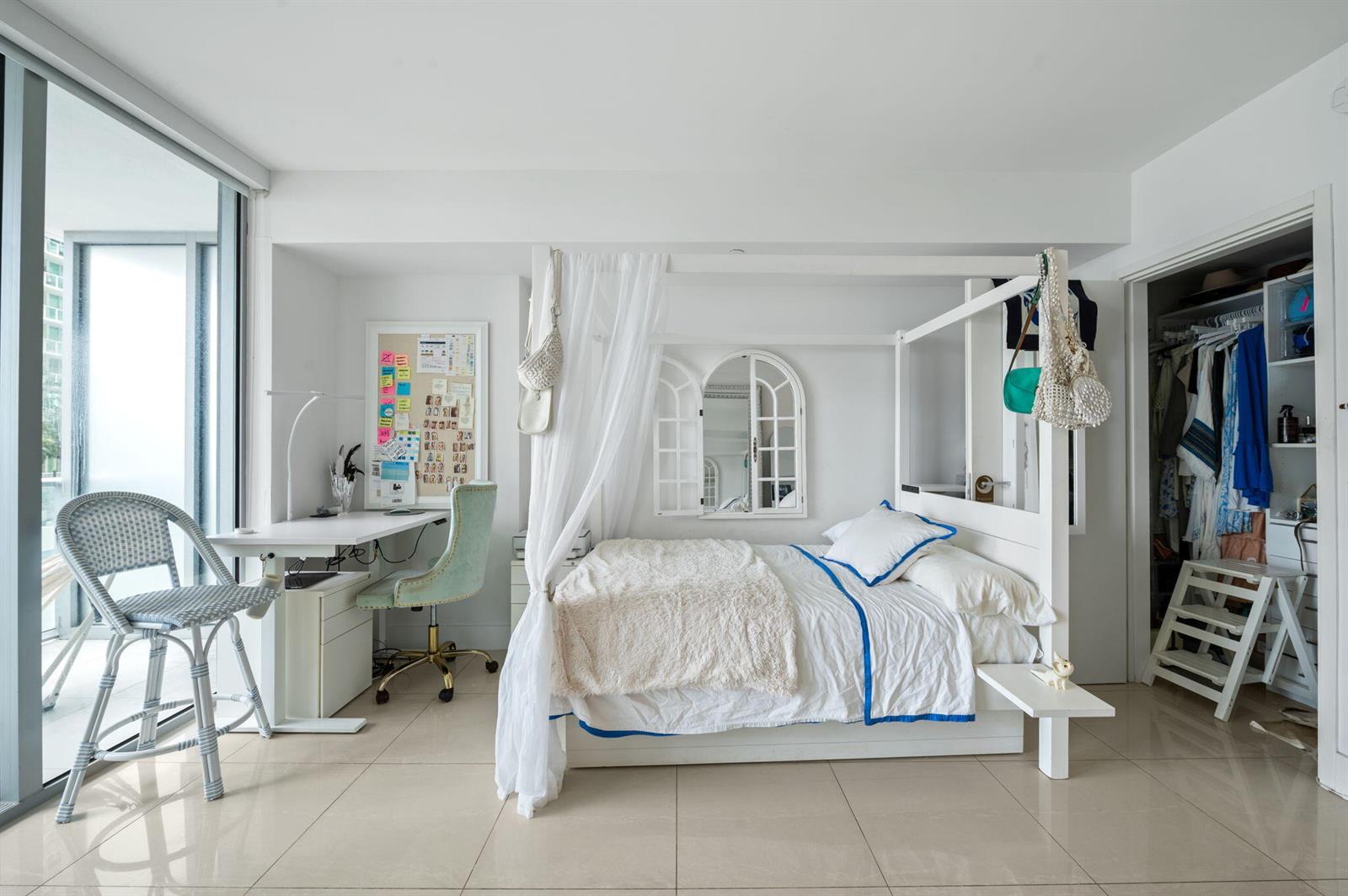 A modern kitchen features stainless steel appliances, light wood cabinetry, and a view of city buildings — 1300 Brickell Bay Drive # 1005, Miami FL 33131, MIAMI, FL