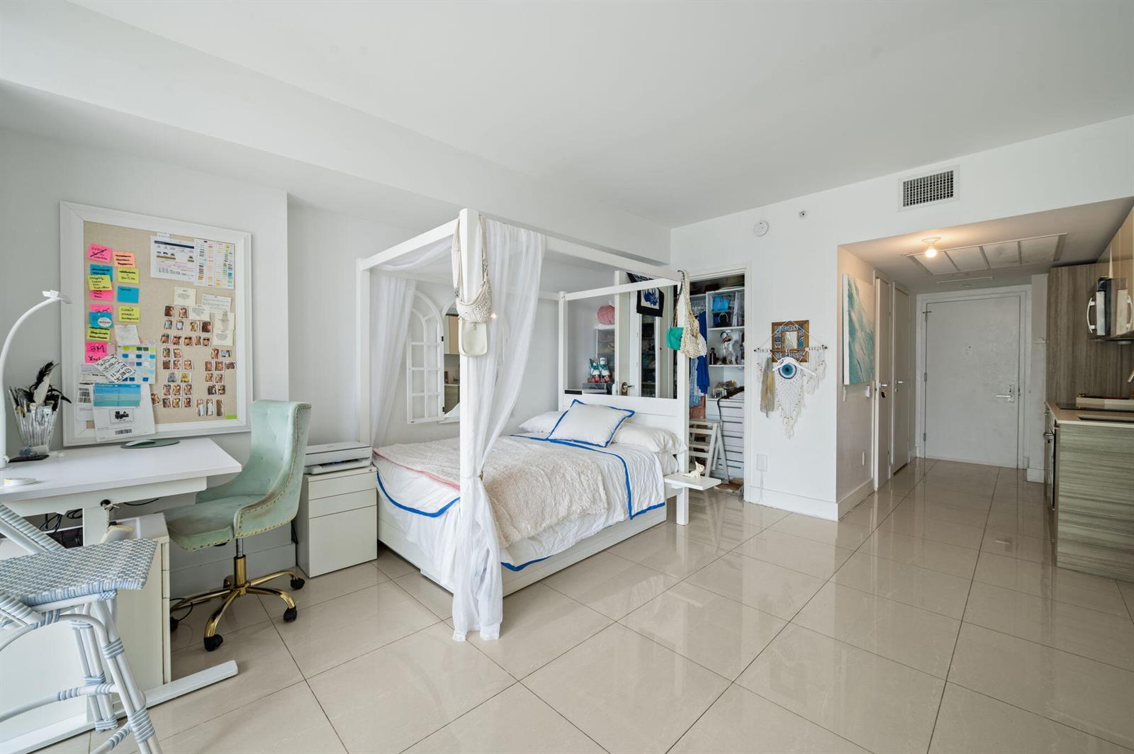 A walk-in shower features beige tile walls, a glass door, and a mosaic tile floor — 1300 Brickell Bay Drive # 1005, Miami FL 33131, MIAMI, FL