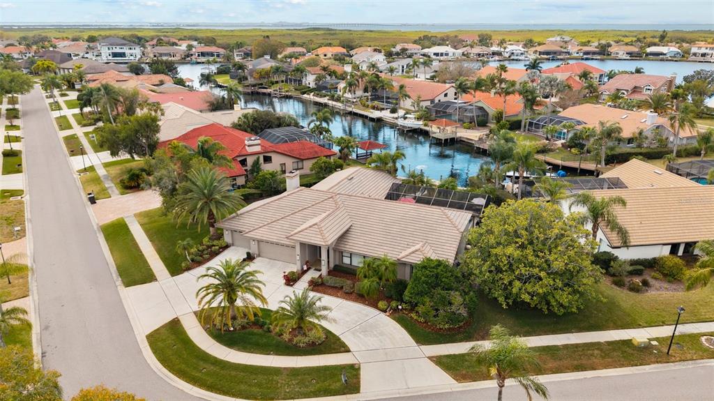 An aerial view of a suburban house with a tile roof and a backyard canal — 4830 LONGWATER WAY, TAMPA, FL