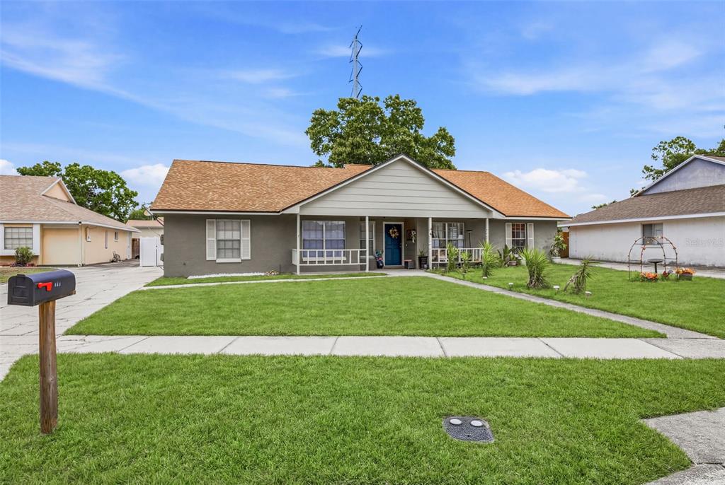 A single-story house with a gray exterior, a covered front porch, and a grassy lawn — 3257 LAUREL DALE DRIVE, TAMPA, FL