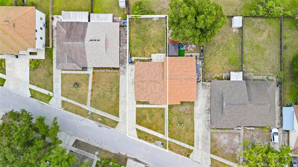 An aerial view shows a residential property with a house, driveway, and fenced backyard — 3257 LAUREL DALE DRIVE, TAMPA, FL