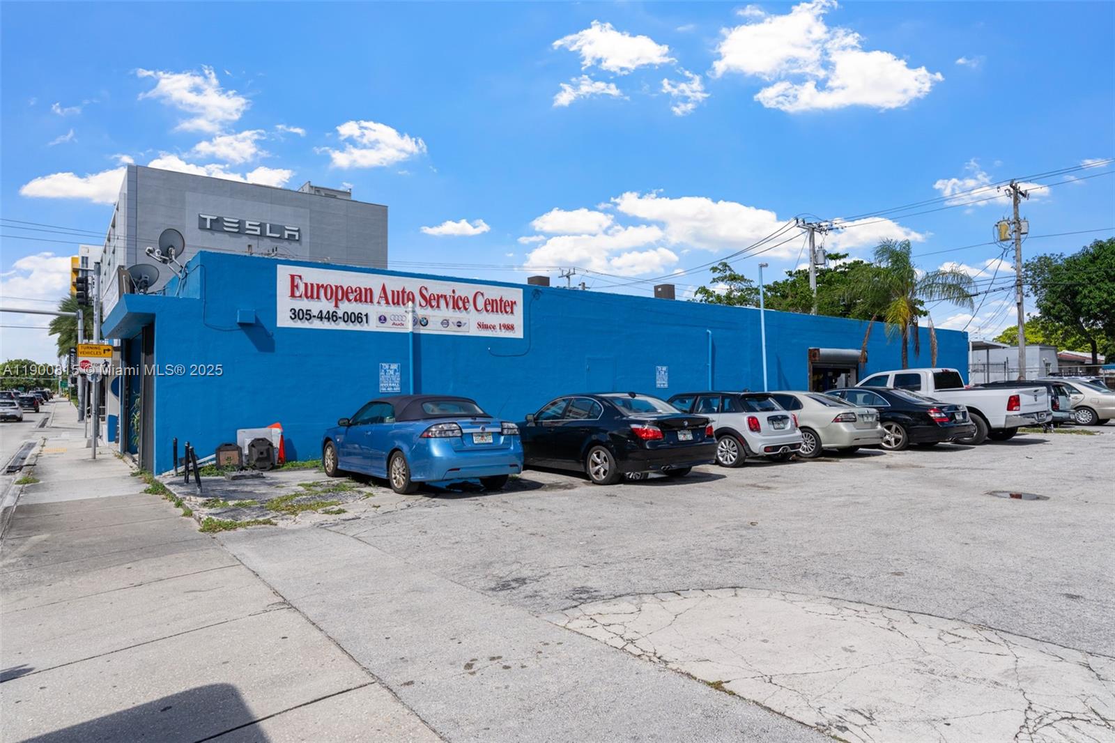 A blue commercial building with a parking lot and several cars parked in front — 3771 Bird Rd, Miami FL 33146, MIAMI, FL