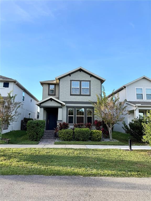 A two-story suburban house with light green siding and a front porch — 1421 HAPPY BIRD LANE, WINTER SPRINGS, FL
