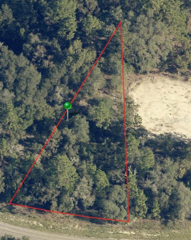 An aerial view shows a triangular, wooded plot of land outlined in red — 6960 N LIME DRIVE, CITRUS SPRINGS, FL