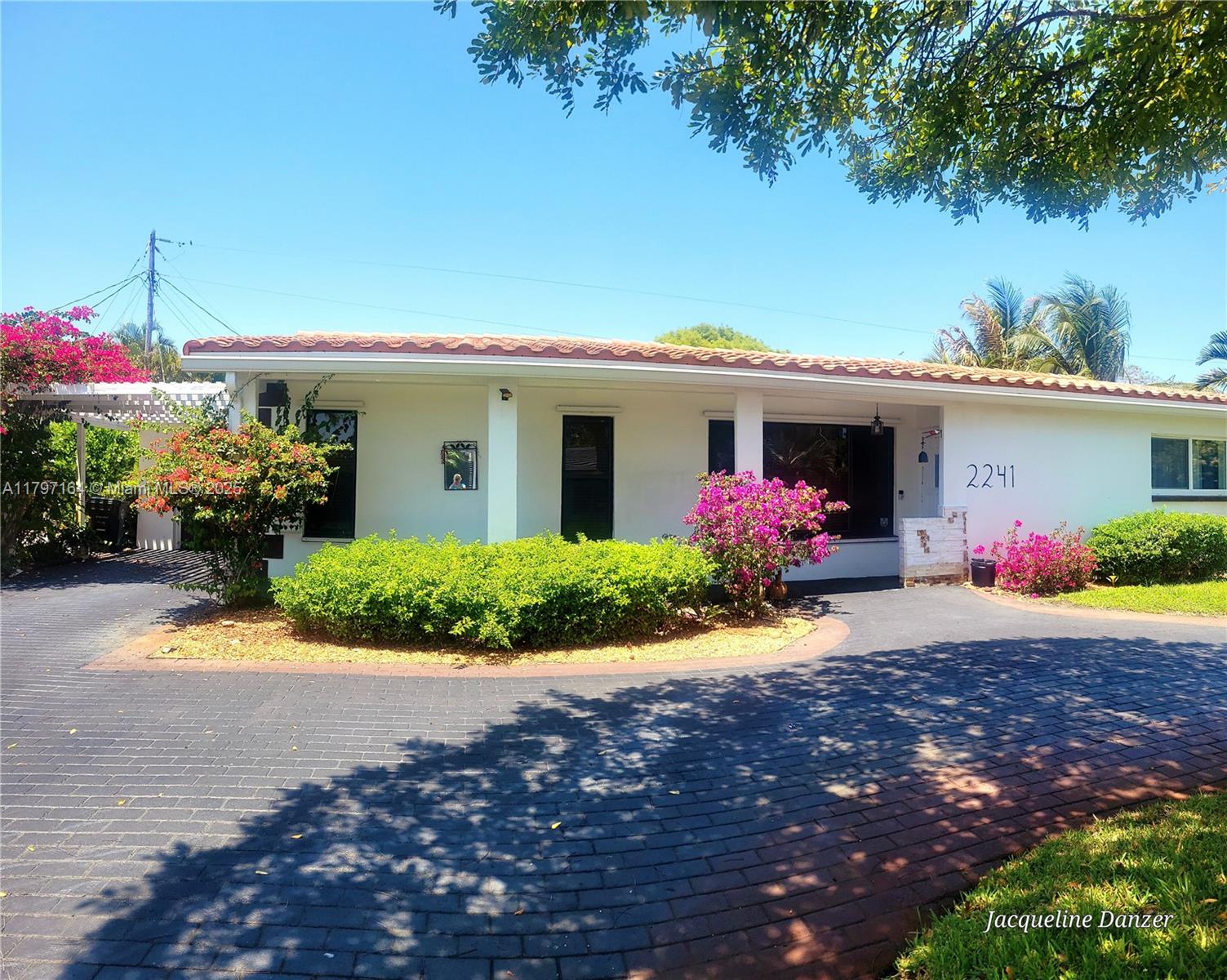 A white single-story house with a tiled roof and a paved circular driveway — 2241 NE 38th St # 0, Lighthouse Point FL 33064, LIGHTHOUSE POINT, FL