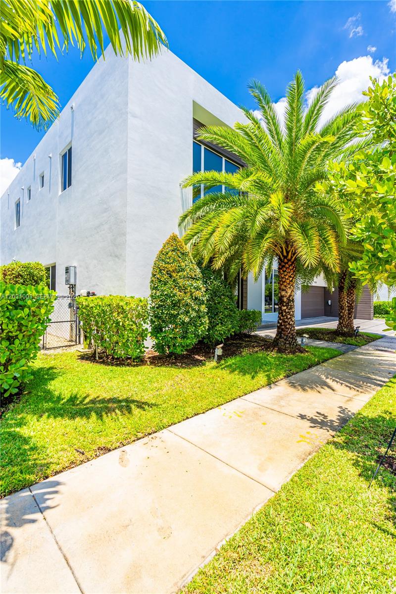A modern white two-story house features a palm tree and a sidewalk in the foreground — 10267 NW 75th Ter # 10267, Doral FL 33178, DORAL, FL