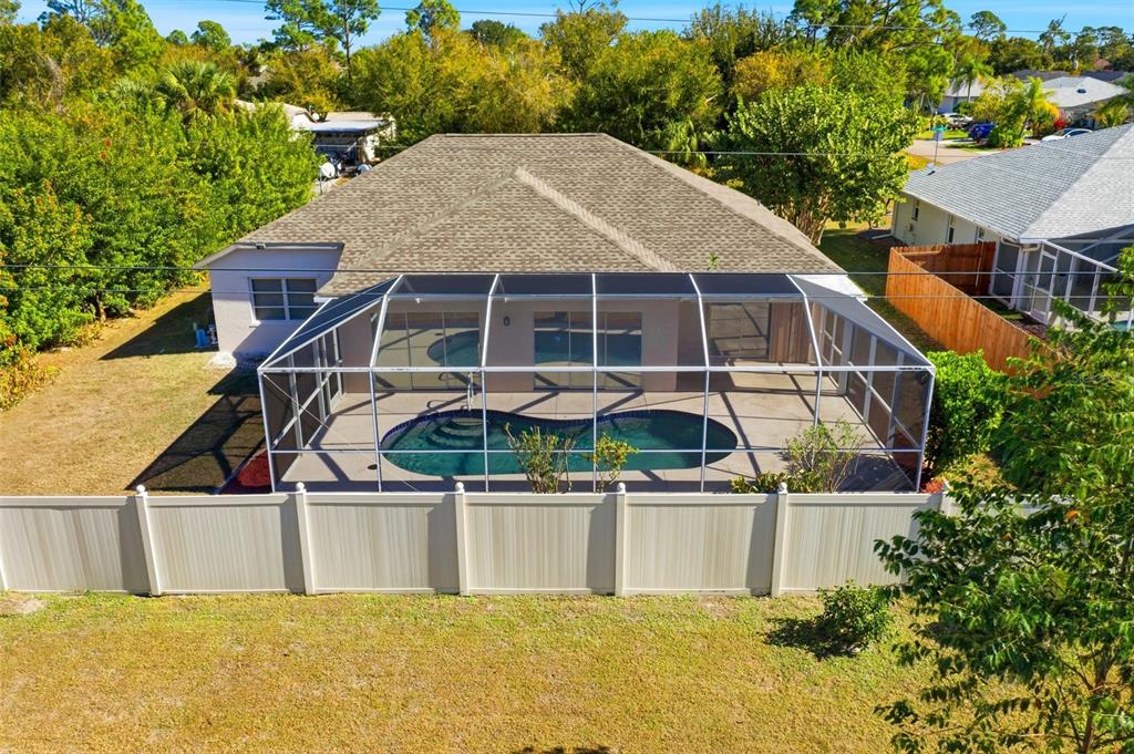 An aerial view of a house with a screened-in pool and a white vinyl fence — 191 ROSEMARY STREET, PORT CHARLOTTE, FL