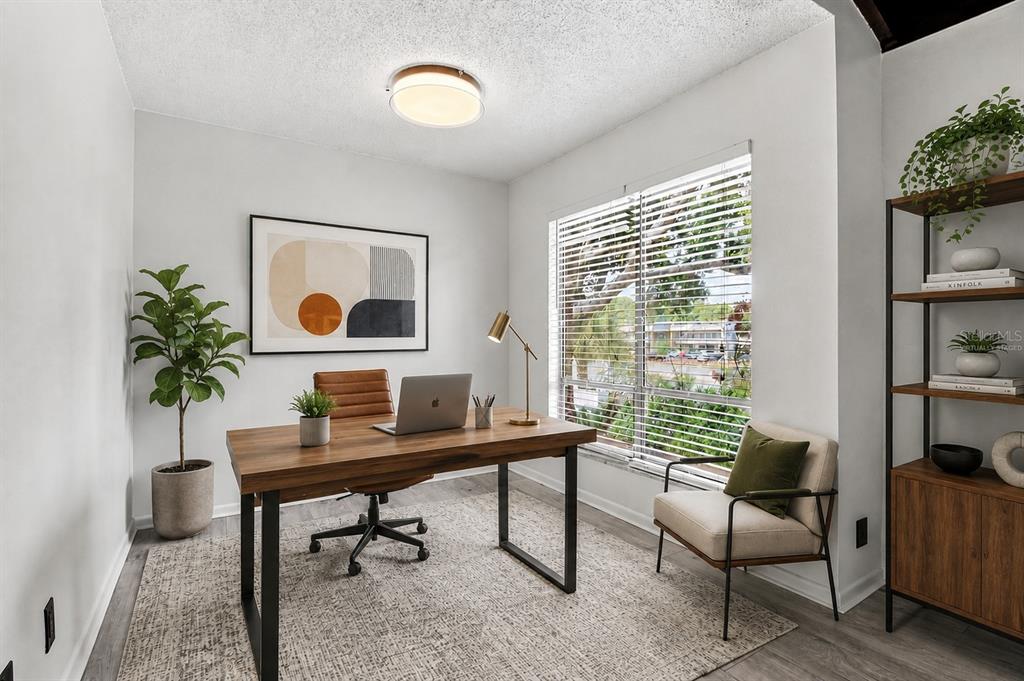 A home office features a wooden desk, a leather chair, a window, and a bookshelf — 10415 CARROLLBROOK CIRCLE UNIT 207, TAMPA, FL