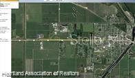 This is an aerial map view of a rural area with fields and a town — 599 US HIGHWAY 27, MOORE HAVEN, FL