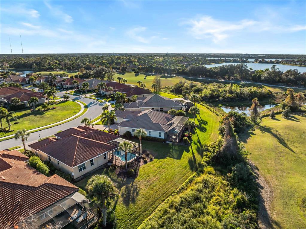 An aerial view of a residential neighborhood featuring homes with tiled roofs and swimming pools — 274 MONTELLUNA DRIVE, NORTH VENICE, FL
