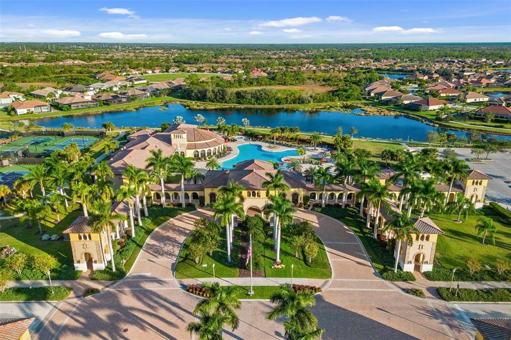 An aerial view shows a large clubhouse with a swimming pool, tennis courts, and landscaping — 20120 RAGAZZA CIRCLE UNIT 202, VENICE, FL
