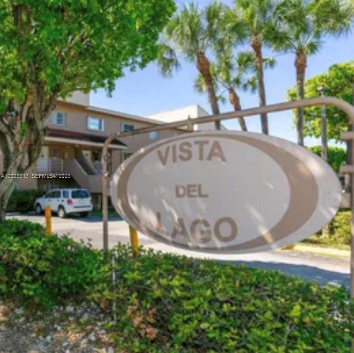 An oval sign for Vista Del Lago stands in front of a multi-story apartment building — 2778 W 60th St # 45, Hialeah FL 33016, HIALEAH, FL