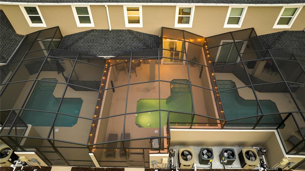 An aerial view shows three adjacent townhome backyards, each featuring a private pool and enclosure — 4399 SCENE LANE, KISSIMMEE, FL