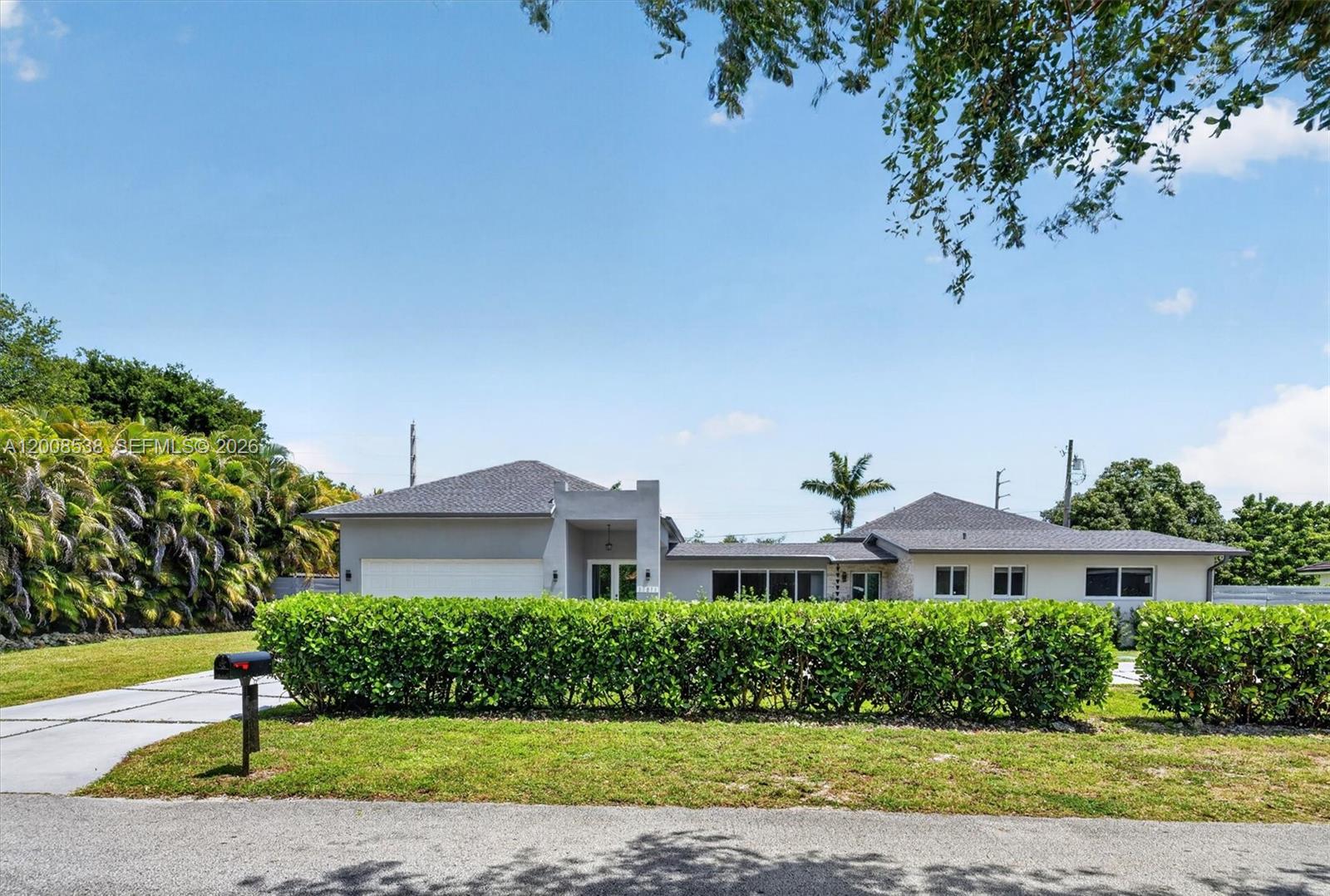 A single-story house with a gray exterior, a two-car garage, and a manicured hedge — 11811 SW 82nd Rd, Miami FL 33156, MIAMI, FL
