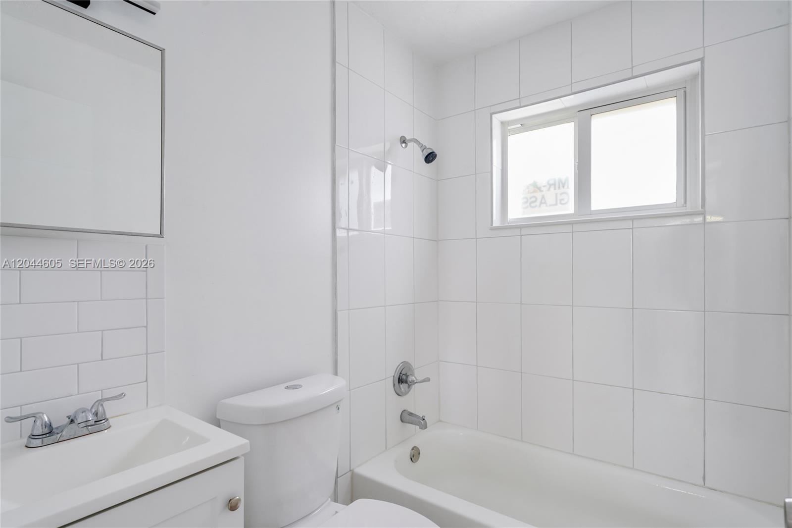 A bathroom features a white vanity, a toilet, and a tiled bathtub shower combination — 1630 NW 18th St # 3, Miami FL 33125, MIAMI, FL