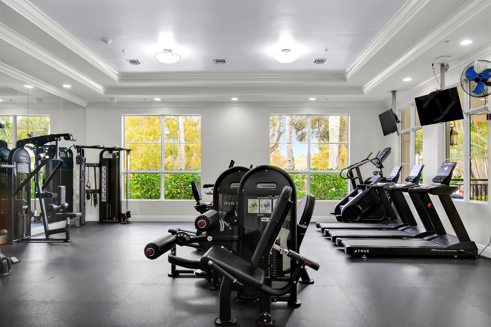 A gym features Nautilus strength equipment, several treadmills, large windows, and a black rubber floor — 1660 Renaissance Commons Boulevard # 2118, Boynton Beach FL 33426, BOYNTON BEACH, FL