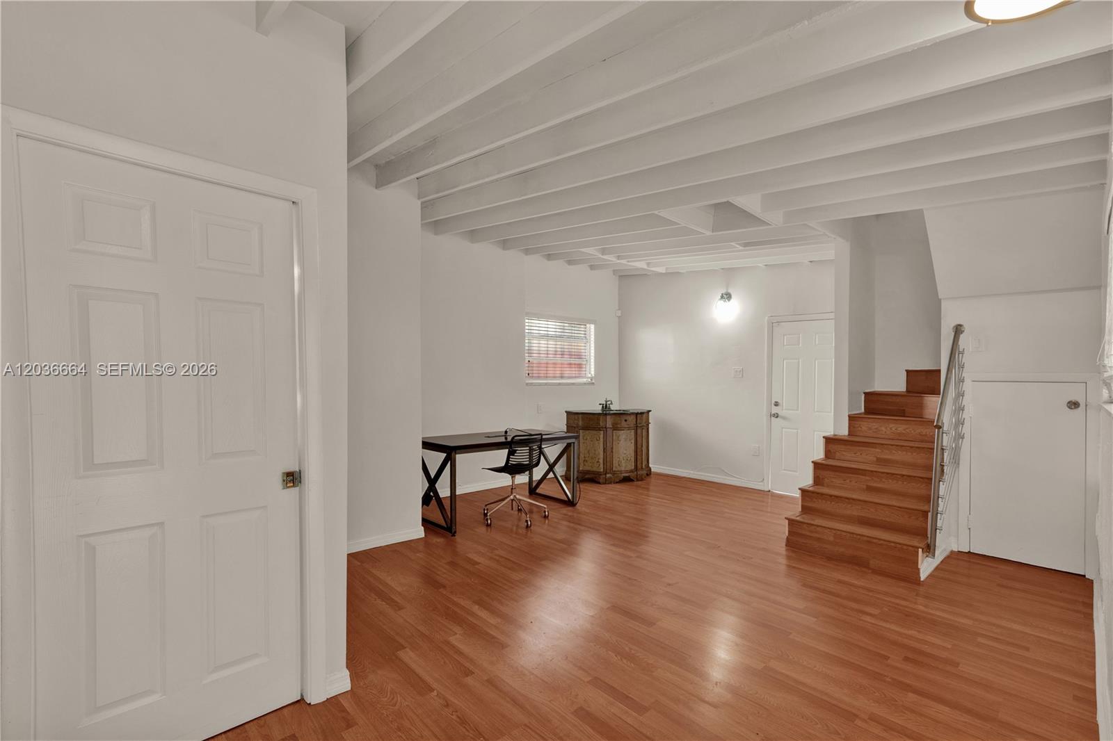 An interior room features wood flooring, a staircase with a metal railing, and exposed ceiling beams — 2145 SW 7th St # 2, Miami FL 33135, MIAMI, FL