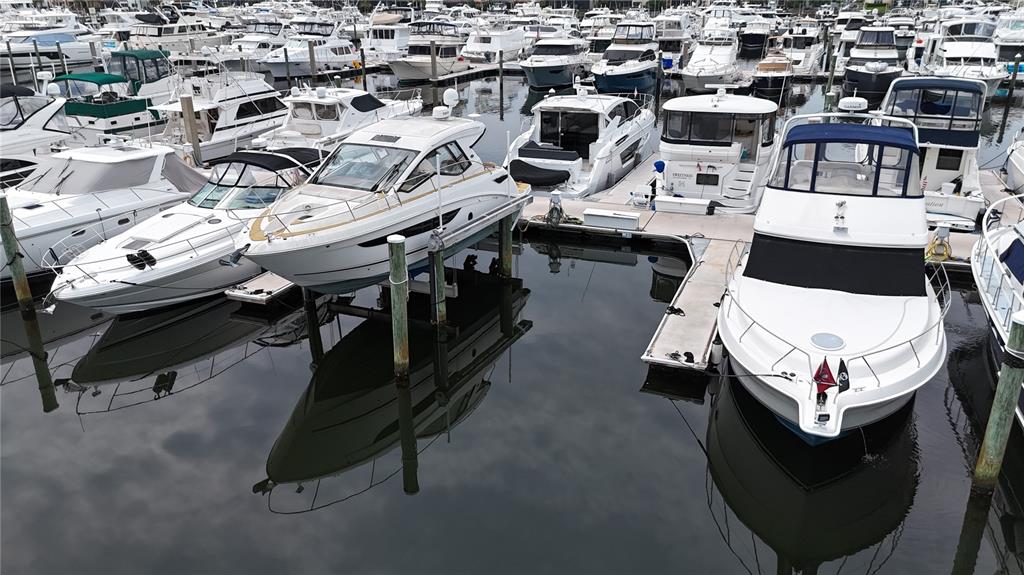 A marina filled with numerous white motor yachts docked in calm water — 102 RIVIERA DUNES WAY UNIT N-14, PALMETTO, FL