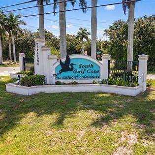 A stone monument sign for South Gulf Cove Waterfront Community stands in a grassy area — 9453 PRESIDENT CIRCLE, PORT CHARLOTTE, FL