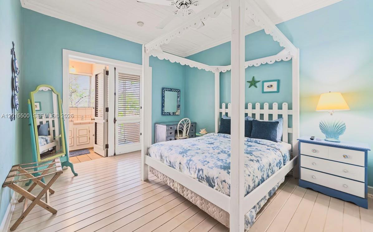 A bedroom features a white canopy bed, light blue walls, and a wooden floor — 12 Murphy Gade, VI 00802, VI