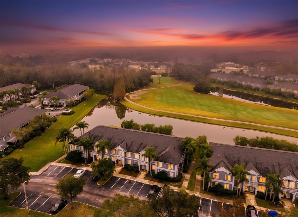 An aerial view of multi-story residential buildings situated next to a pond and golf course — 18214 PARADISE POINT DRIVE, TAMPA, FL