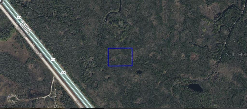 This aerial map shows a rectangular plot of land highlighted in blue near a highway — CAPE CANAVERAL, PALM BAY, FL