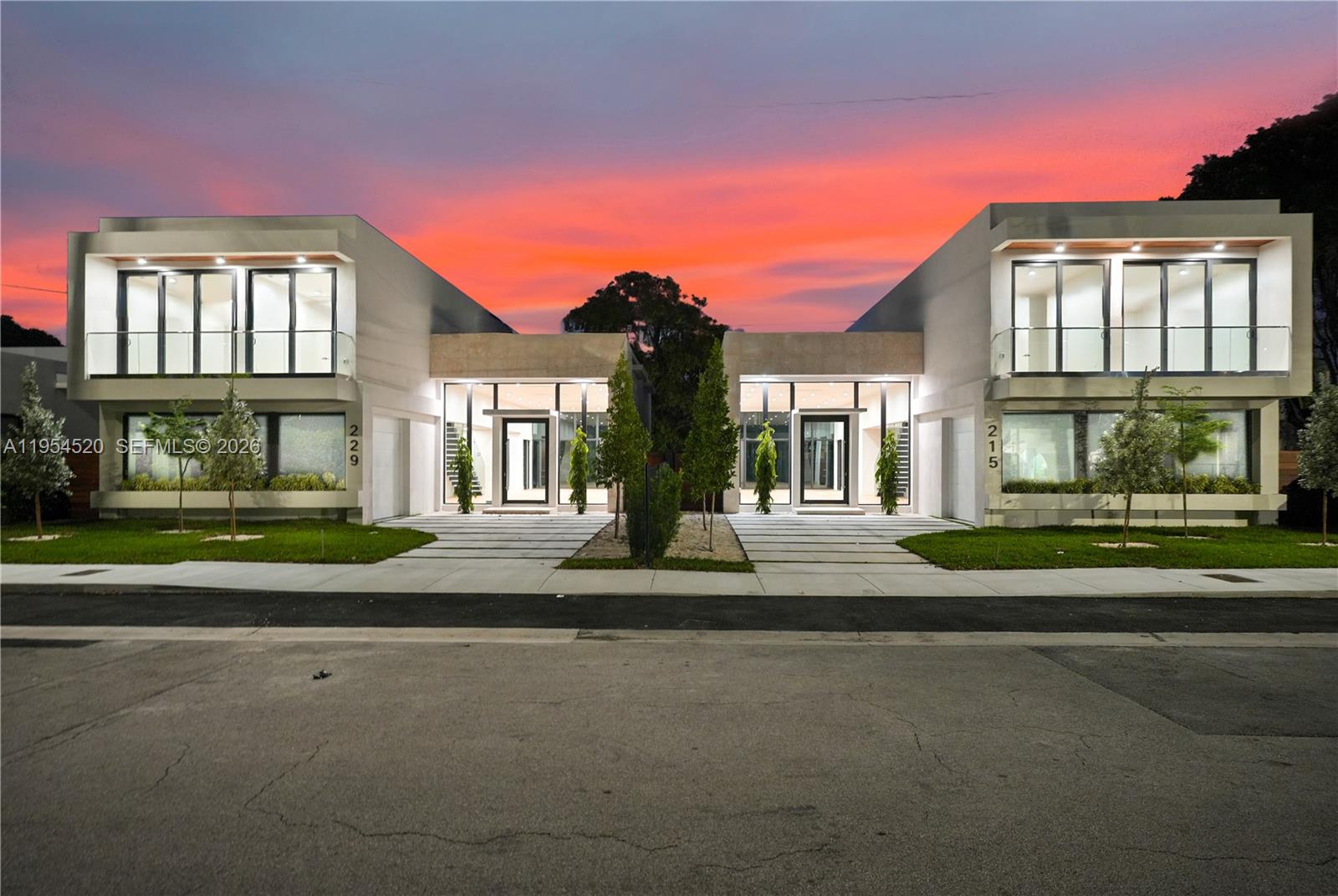 Two modern two-story residential buildings stand side-by-side under a vibrant sunset sky — 229 NW 42nd St, Miami FL 33127, MIAMI, FL