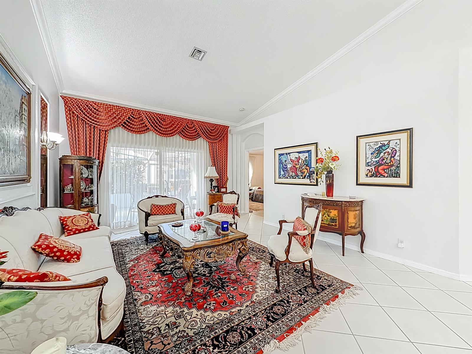 A formal living room features white tile floors, a large red patterned rug, and ornate furniture — 6174 Caladium Road, Delray Beach FL 33484, DELRAY BEACH, FL
