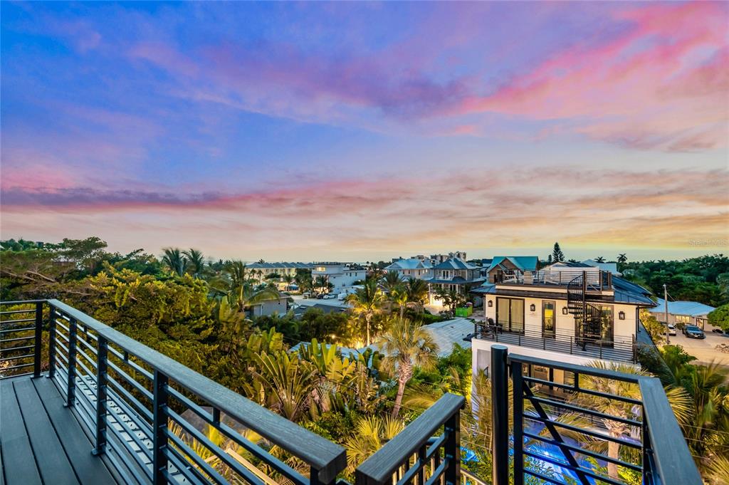 A view from a balcony overlooking a residential neighborhood at sunset — 209 GARFIELD DRIVE, SARASOTA, FL