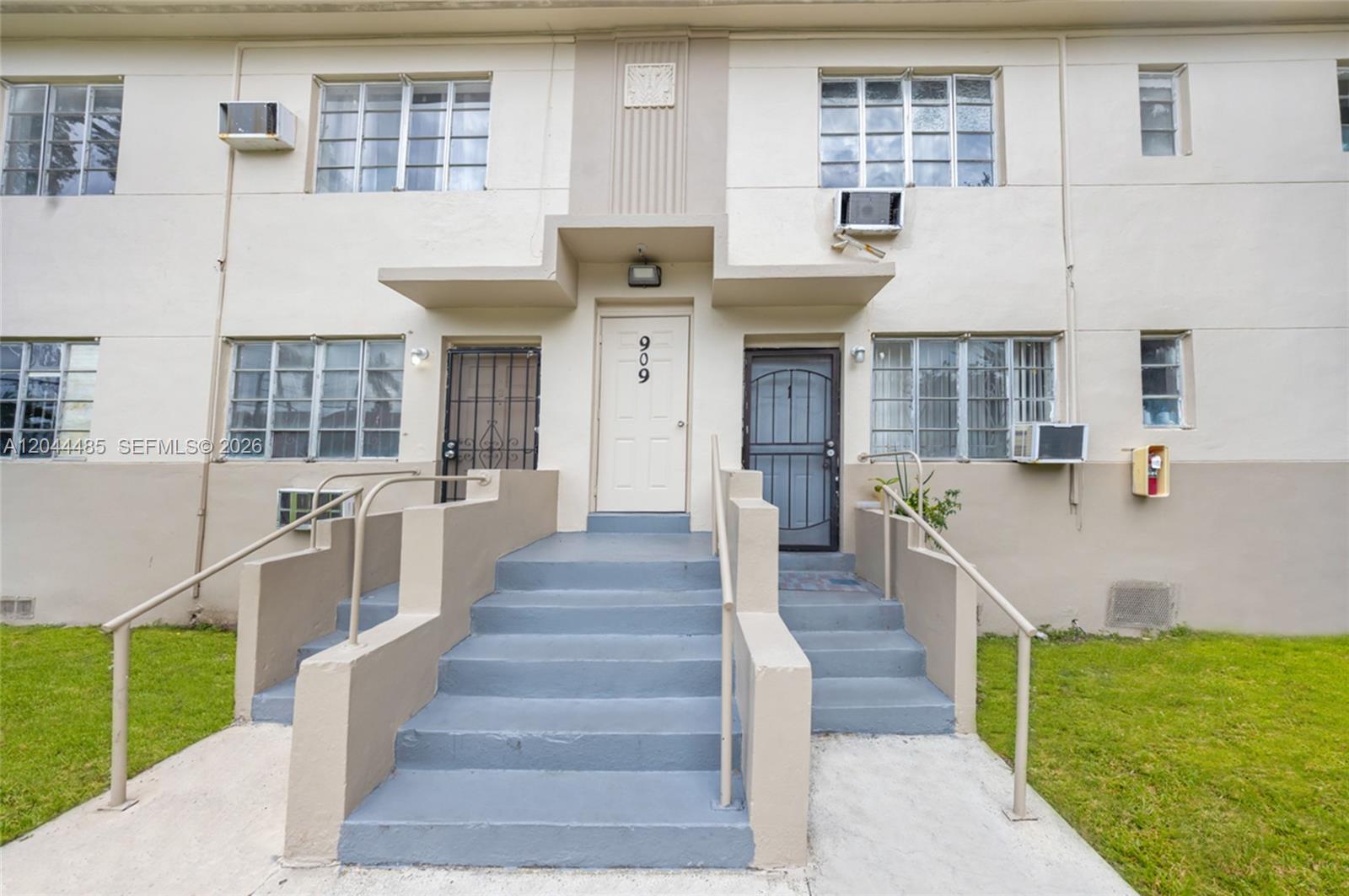 The exterior of a two-story apartment building features concrete stairs leading to two separate entrances — 931 SW 3rd St, Miami FL 33130, MIAMI, FL