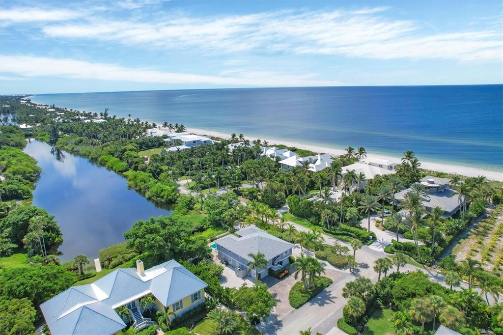 An aerial view of coastal homes nestled between a calm lake and the ocean beach — 4010 40TH STREET W, BOCA GRANDE, FL