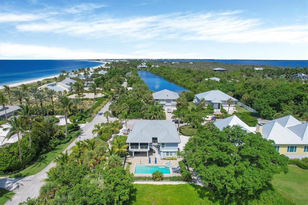 An aerial view of a coastal neighborhood featuring houses, a swimming pool, and a lagoon — 4010 40TH STREET W, BOCA GRANDE, FL