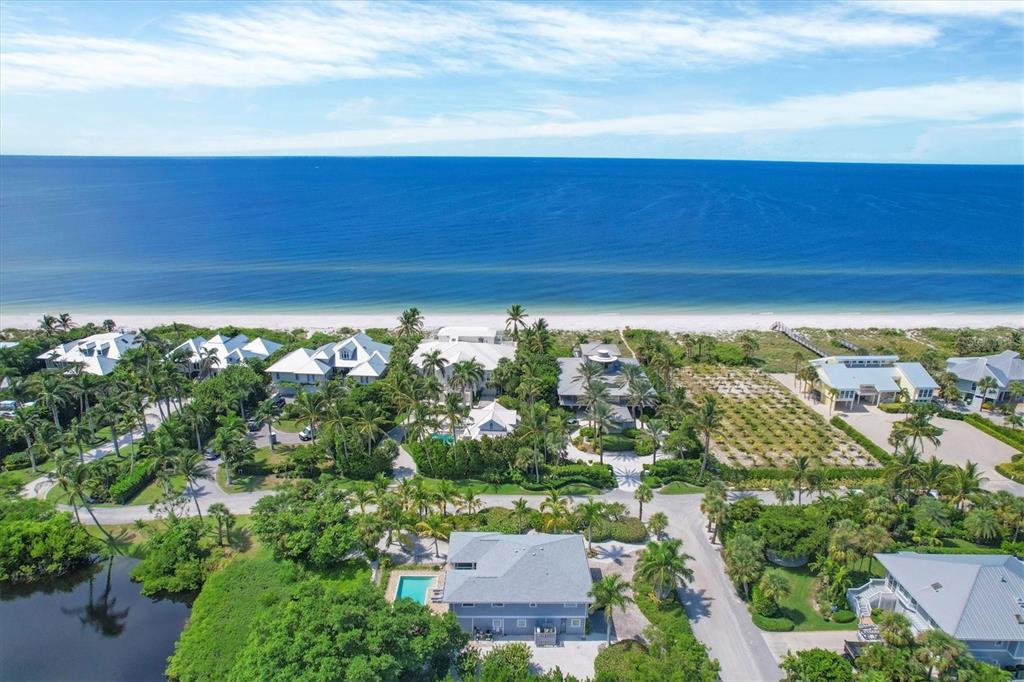 An aerial view of beachfront houses surrounded by lush tropical vegetation and a small pond — 4010 40TH STREET W, BOCA GRANDE, FL