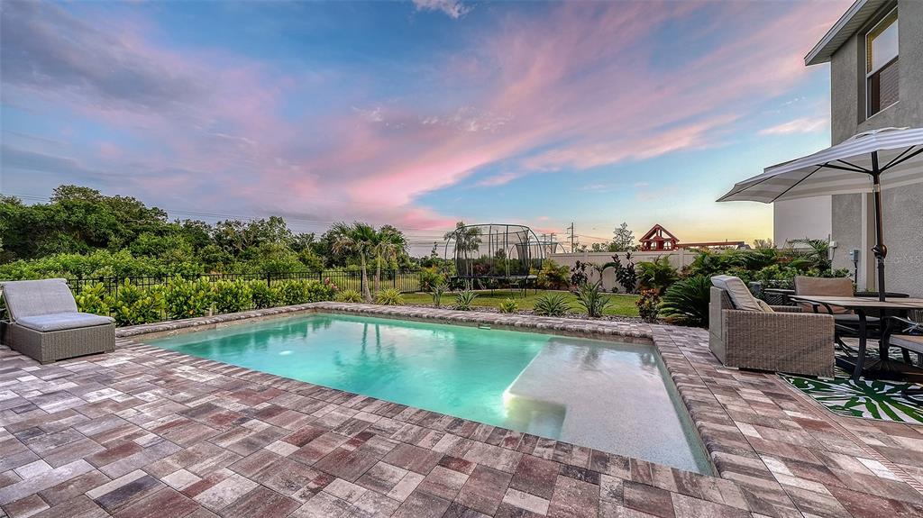 An aerial view of a two-story house featuring a backyard pool and fenced lawn — 10016 BIG MARSH TERRACE, PARRISH, FL