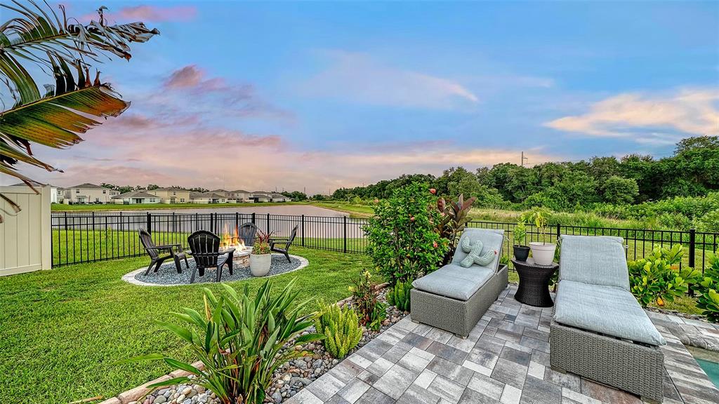 A two-story suburban house features a tan stucco exterior, a two-car garage, and landscaping — 10016 BIG MARSH TERRACE, PARRISH, FL