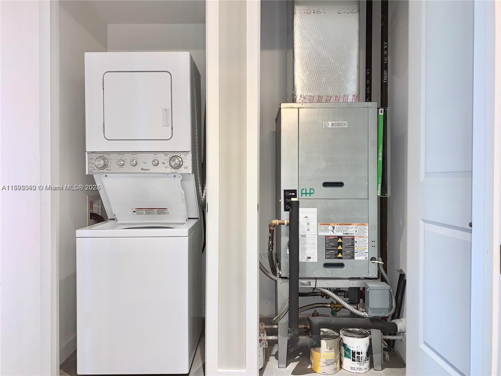 A laundry closet contains a stacked washer-dryer unit next to a Bosch HVAC air handler — 1600 NE 1st Ave # 1003, Miami FL 33132, MIAMI, FL