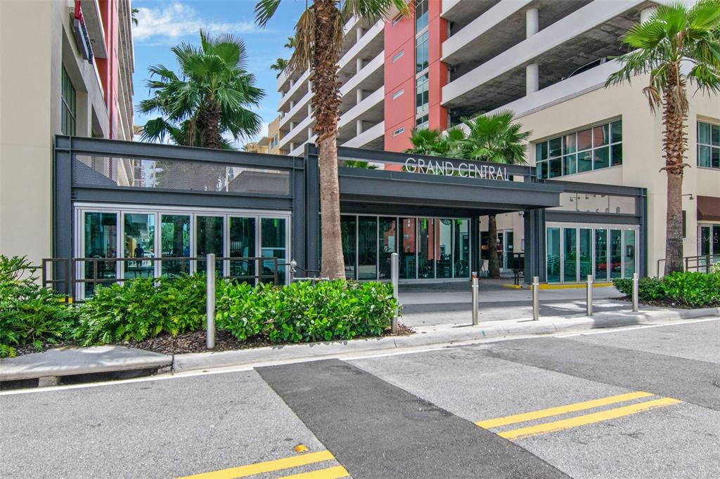The exterior of a modern building features a Grand Central sign and glass storefronts — 1120 E KENNEDY BOULEVARD UNIT 1211, TAMPA, FL