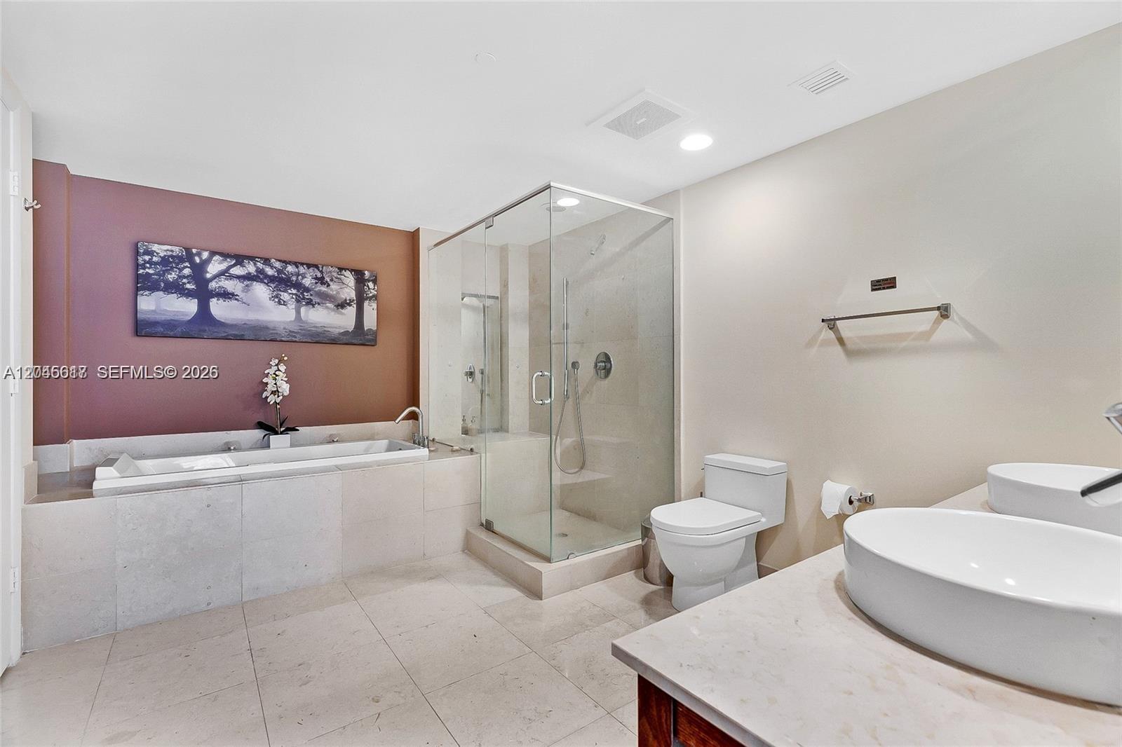 A bathroom features a soaking tub, glass-enclosed shower, toilet, and dual vessel sinks — 485 Brickell Ave # 3602, Miami FL 33131, MIAMI, FL