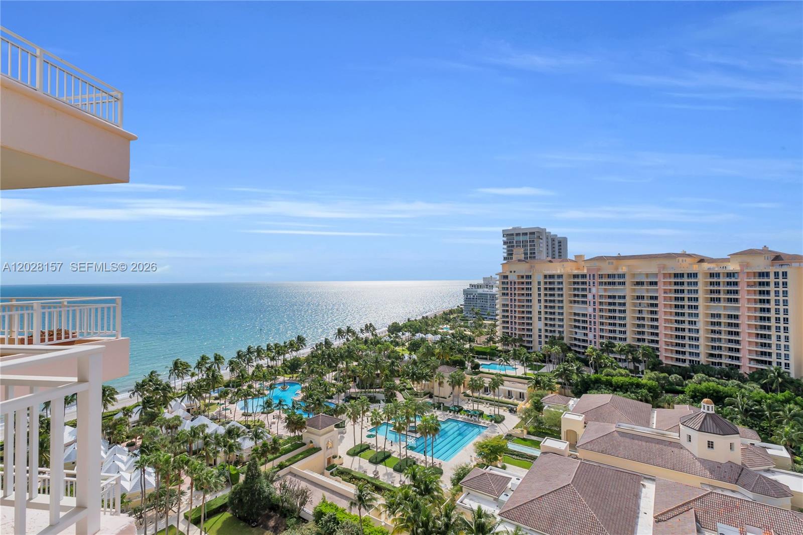 An elevated view of a coastal resort featuring swimming pools, palm trees, and oceanfront buildings — 791 Crandon Blvd, Key Biscayne FL 33149, KEY BISCAYNE, FL
