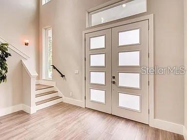 A modern two-story house features a blue front door, gray accents, and a covered porch — 200 E GRANT STREET, ORLANDO, FL
