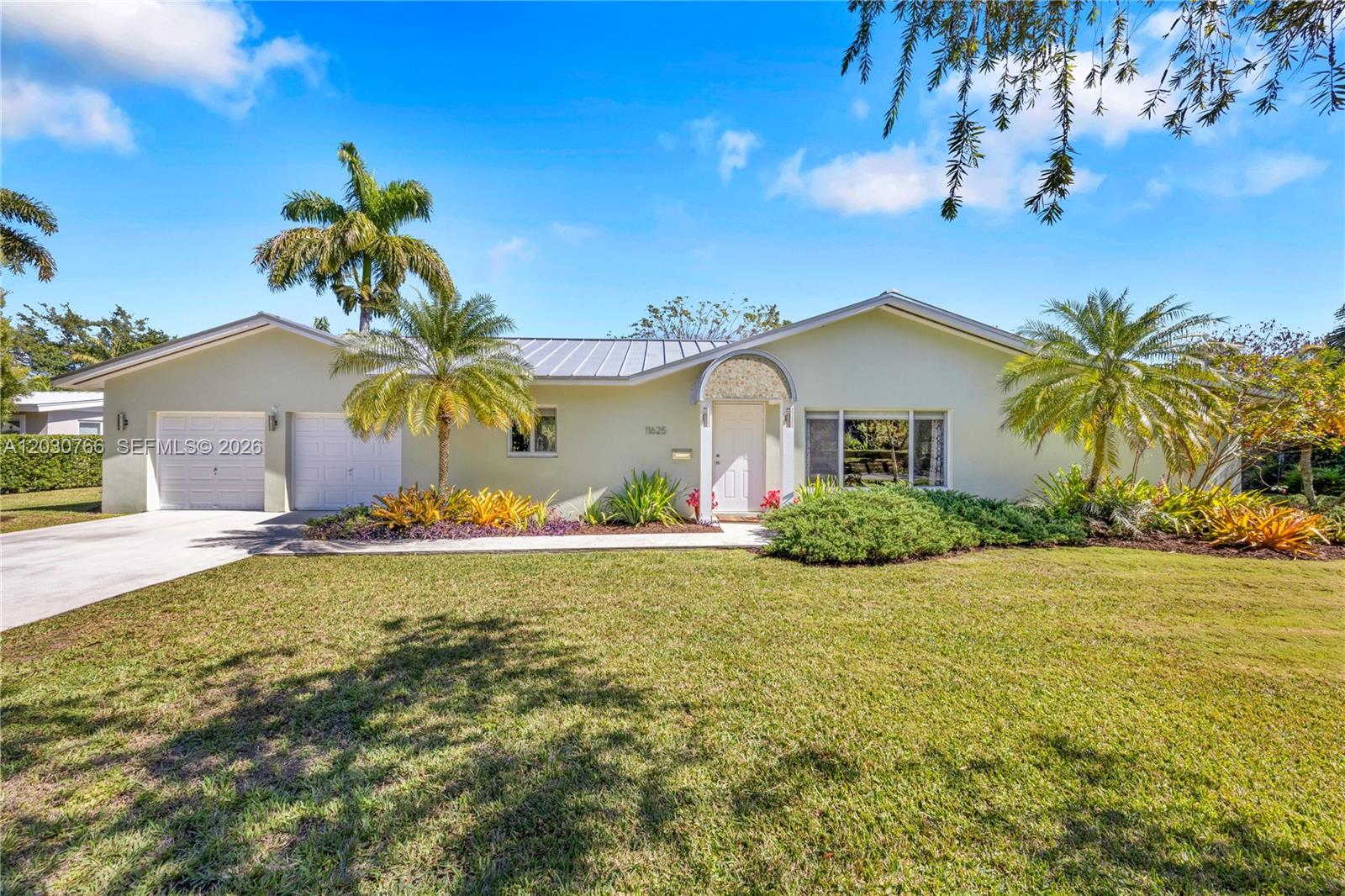 A single-story house with a light green exterior, a metal roof, and a two-car garage — 11625 SW 70th Ave, Pinecrest FL 33156, PINECREST, FL