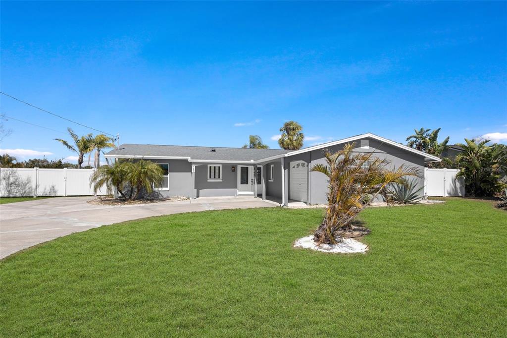 A bright entryway features light-colored tile flooring, a white front door, and louvered closet doors — 729 SPANISH MAIN DRIVE, APOLLO BEACH, FL
